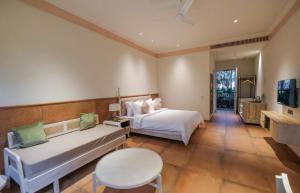 a large bedroom with a bed and a table and a table sidx sidx at The Forresta Checks-In, Jaipur in Jaipur