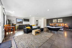 a living room with a couch and a bath tub at Blaze Rock Retreat in Halls Gap