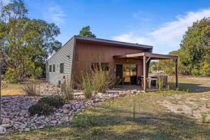 a barn conversion with a table and a gazebo at Blaze Rock Retreat in Halls Gap