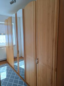 a mirror on a wooden cabinet in a room at Ferienwohnung Lene im Lauertal - Rhön in Maßbach