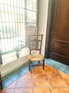 a chair sitting in front of a door at Casa cubo in Alhama de Granada