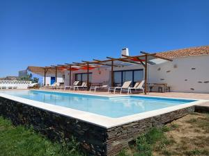 a villa with a swimming pool and a house at Monte Costa Raiz in Mértola