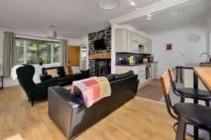 a living room with a couch and a table at Finest Retreats - Dyffryn in Betws-y-coed