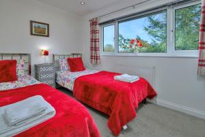 a bedroom with two beds and a window at Finest Retreats - Dyffryn in Betws-y-coed