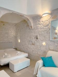 a white room with two beds and a couch at Suite Ninfea romantic suite Ostuni center in Ostuni