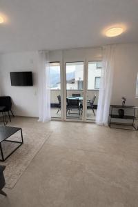 a large living room with a table and chairs at Apartments Nilada in Zirl