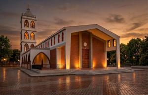 a church with a clock tower at night at INTERNO 13 Apartament in Spinazzola