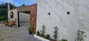 a building with a garage with a door and some plants at Girassol & Estética in Macapá