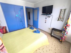 a room with a bed and a blue door at Studio By the Beach in Saronida