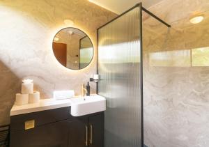 a bathroom with a sink and a shower at Kingswood Pods and Lodges in Fort William +56 photos