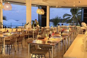 a restaurant with tables and chairs with a view of the ocean at Trogon's Perch in San Isidro