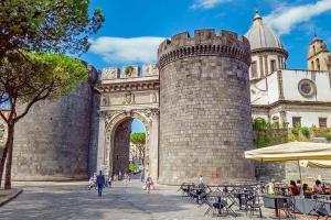 a large castle with people walking in front of it at Angioino Central in Naples +17 photos