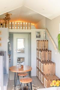 a dining room with a table and some boxes at Kemphaontje is a Magic Tiny House with a view in Anloo
