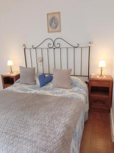 a bedroom with a large bed with two night stands at MAISON des FORGES in Buffon