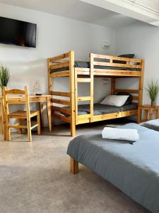 a bedroom with bunk beds and a table and a desk at Chalet Ma Neou Village Vacances in Les Angles +17 photos