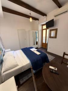 a bedroom with a bed and a table in it at Anema e Core Salerno rooms in Salerno
