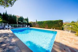a swimming pool with blue water in a yard at 6P apartment in a Citadelle with POOL - Saint-Tropez in Saint-Tropez +14 photos