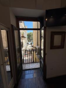 an open door to a balcony with a view of a street at Anema e Core Salerno rooms in Salerno