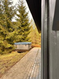 a house with a boat sitting on a porch at Silarozes in Mālpils