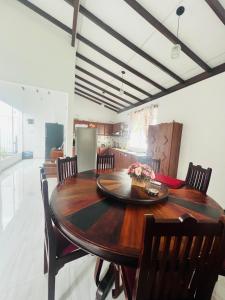 a dining room with a wooden table and chairs at White House in Ranala