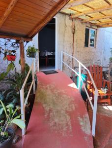a walkway leading to a house with a red carpet at Silvia Apart Confort in Puerto Iguazú