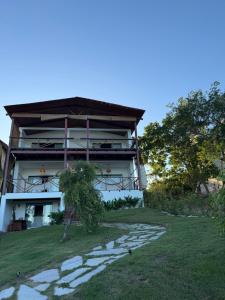 a house on top of a hill with a walkway at Pousada Almaré Boipeba in Ilha de Boipeba