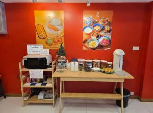 a counter with a table with food on it at Hugg daily airport 5 in Ban Khlong Thewa