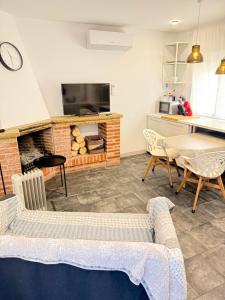a living room with a couch and a fireplace at ASV Alojamiento in Pineda de Mar