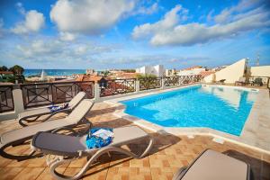 a swimming pool on the roof of a building at Patio Antigo Residence in Santa Maria
