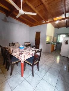 a dining room table with chairs and a ceiling at Silvia Apart Confort in Puerto Iguazú +4 photos