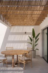 a dining room with a wooden table and chairs at Casa Victoria El Roque in Roque