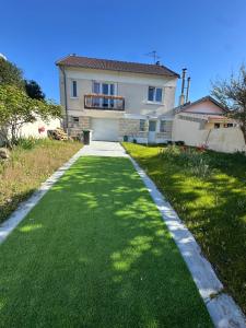 a house with a green lawn in front of it at Maison Grand Paris avec jardin et parking privé proche RER B et M14 in Arcueil