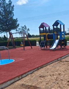 a playground with two slides and a slide at Sunset Green 01 in Paphos