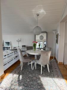 a dining room with a table and chairs at Privat strandvilla i vackra Geta in Geta +22 photos