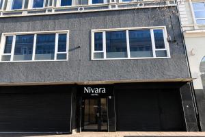 a building with two windows and a naya store at Nivara Hotel in Hamburg
