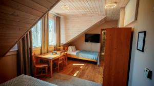 a bedroom with a bed and a table in a room at Penzion Mlýn Sedlec in Sedlec