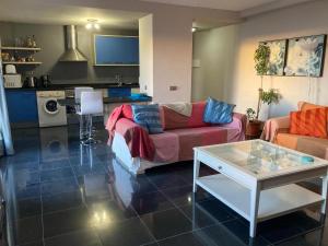 a living room with two couches and a table at Beach Apartment Marfolin 17 El Cotillo Adults Only in El Cotillo