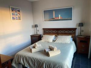 a bedroom with a bed with two pillows on it at Beach Apartment Marfolin 17 El Cotillo Adults Only in El Cotillo +8 photos