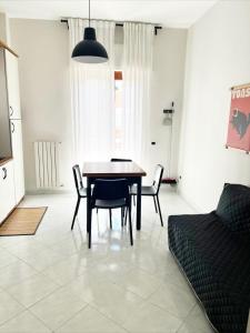 a dining room with a table and chairs and a couch at TERRA DI SUD Matera - Free secure parking in Matera
