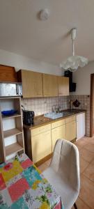 a kitchen with a table and a dining room at Ferienhaus Greiling in Quedlinburg +12 photos