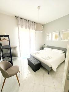 a bedroom with a bed and a chair in it at TERRA DI SUD Matera - Free secure parking in Matera