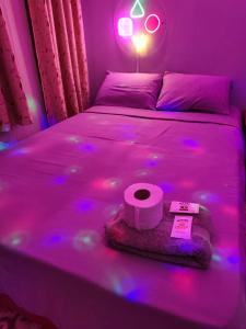 a bed with a roll of toilet paper on it at Hotel Prince in Barranca