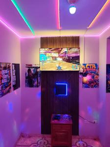 a room with a tv and a purple light at Hotel Prince in Barranca
