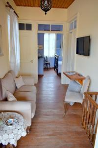 a living room with a couch and a table at Traditional Villa Marina in Chios