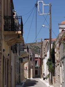 an alley with buildings and a balcony on a building at Traditional Villa Marina in Chios