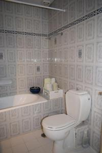 a bathroom with a toilet and a sink and a tub at Traditional Villa Marina in Chios +24 photos