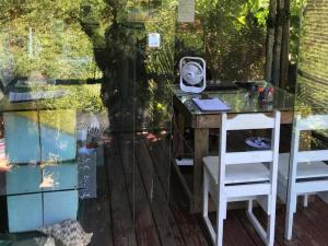 a desk with a mirror on top of a table at Mantis and Moon Surf Paradise & Adventure Lodge in Hibberdene