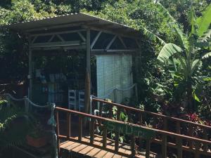 a wooden deck with a gazebo in a garden at Mantis and Moon Surf Paradise & Adventure Lodge in Hibberdene