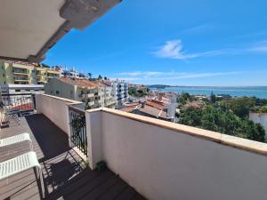 a balcony with a view of the ocean and buildings at Bright by the Beach - by CoH in Cruz Quebrada