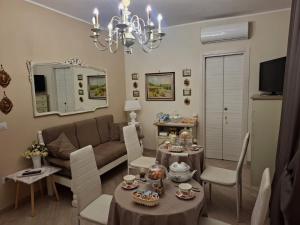 a living room with a couch and a table and chairs at La Petite Maison d'Emilie in Lauria Inferiore